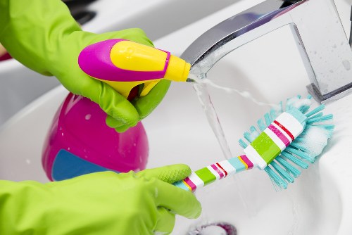 Supervisor checking cleaning equipment for safe use